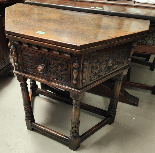 An 17th Century styel oak carved hall table with fold over top