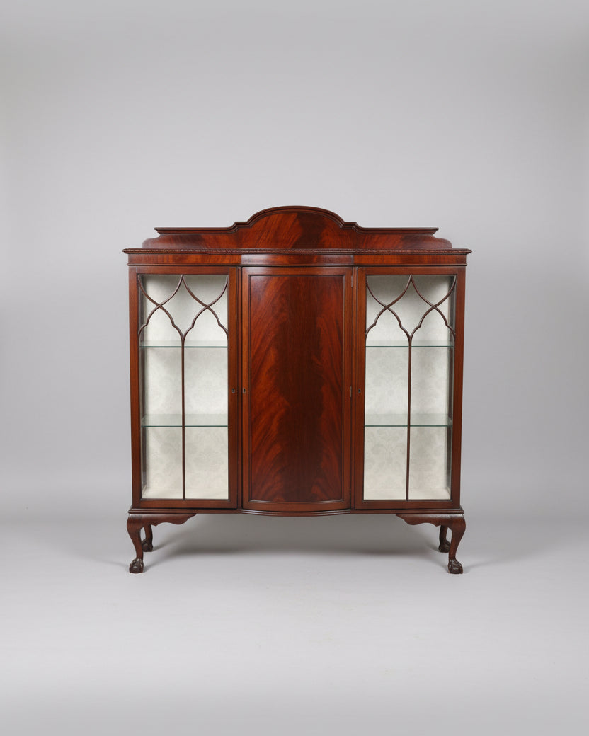 Wooden display cabinet with glass doors in a room setting