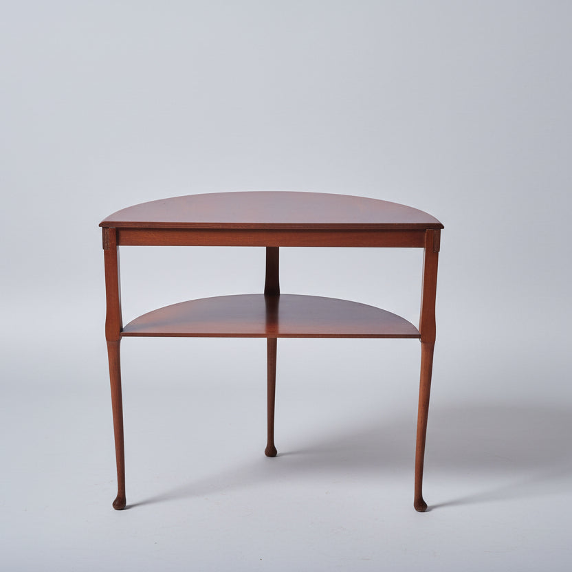 Wooden corner table with a chair on a textured floor