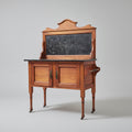 Wooden cabinet with a blackboard top on a red patterned rug