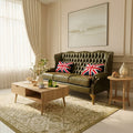 Living room with a green sofa, wooden coffee table, and decorative pillows.