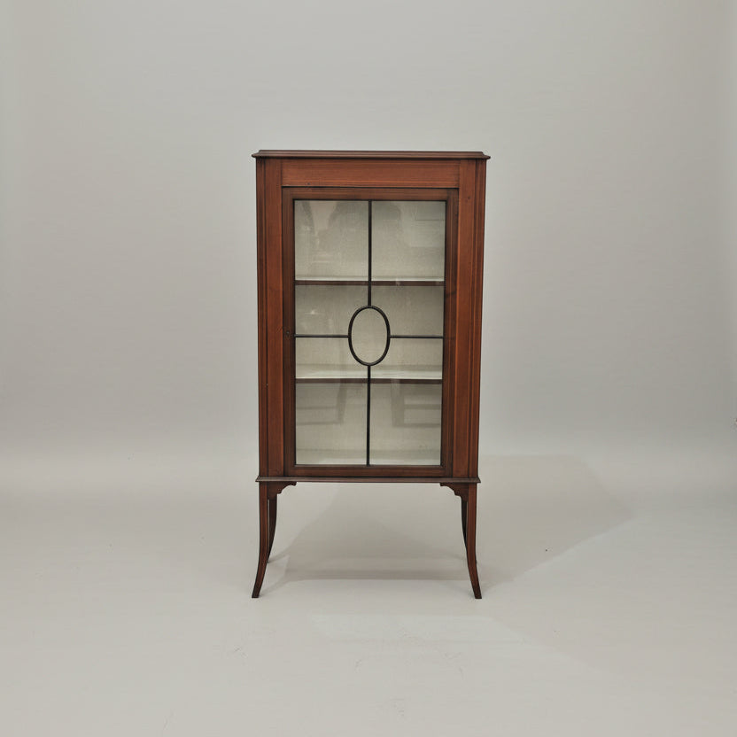 Wooden display cabinets with glass doors in a showroom setting.