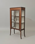Wooden display cabinet with glass doors on a plain background