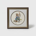 A framed circular art print featuring a whimsical illustration of a rabbit in a blue coat and a small figure with a hat, displayed on a wooden surface.
