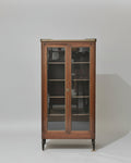 Furniture store with wooden display cabinet, sofa, and various items.
