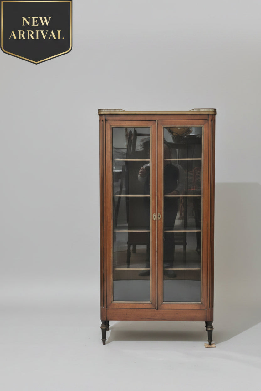 Furniture store with wooden display cabinet, sofa, and various items.