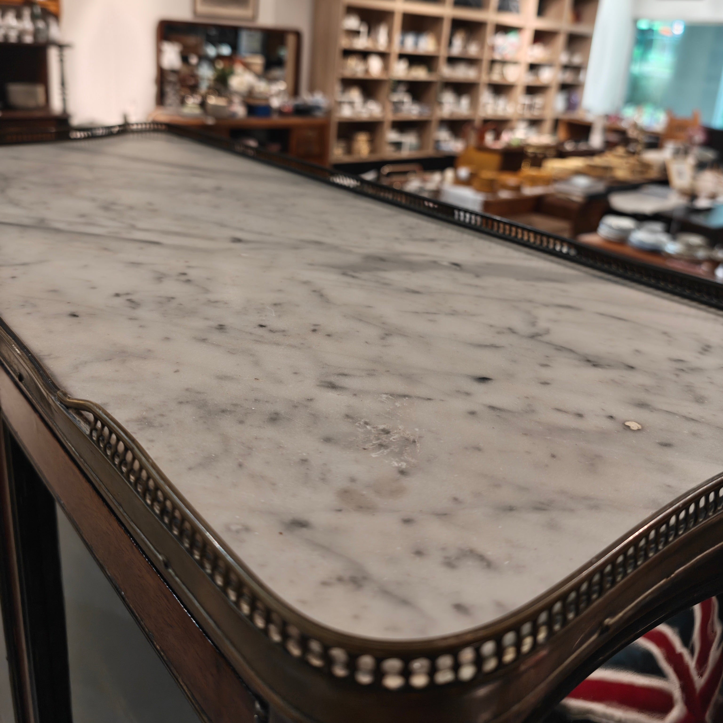 Marble countertop in a store with shelves and products in the background