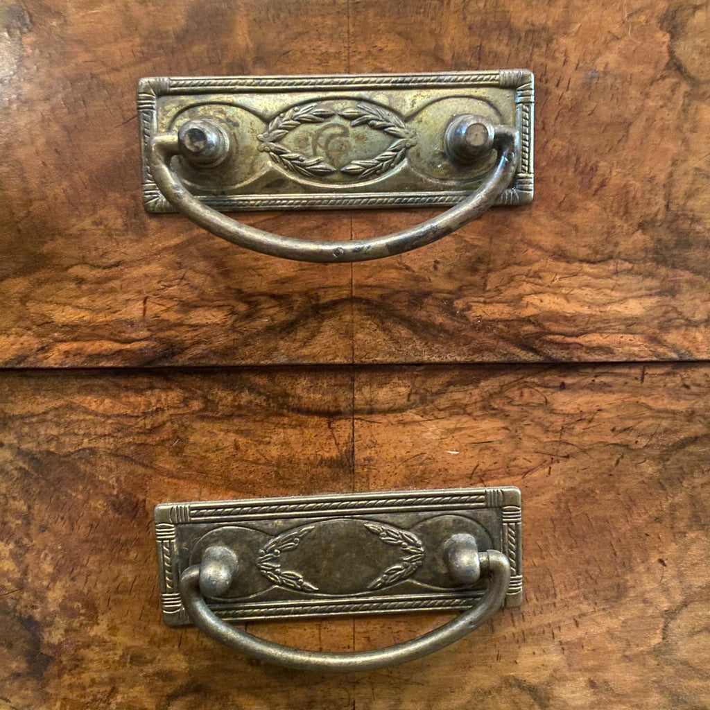 Close-up of an old wooden drawer with metal handles
