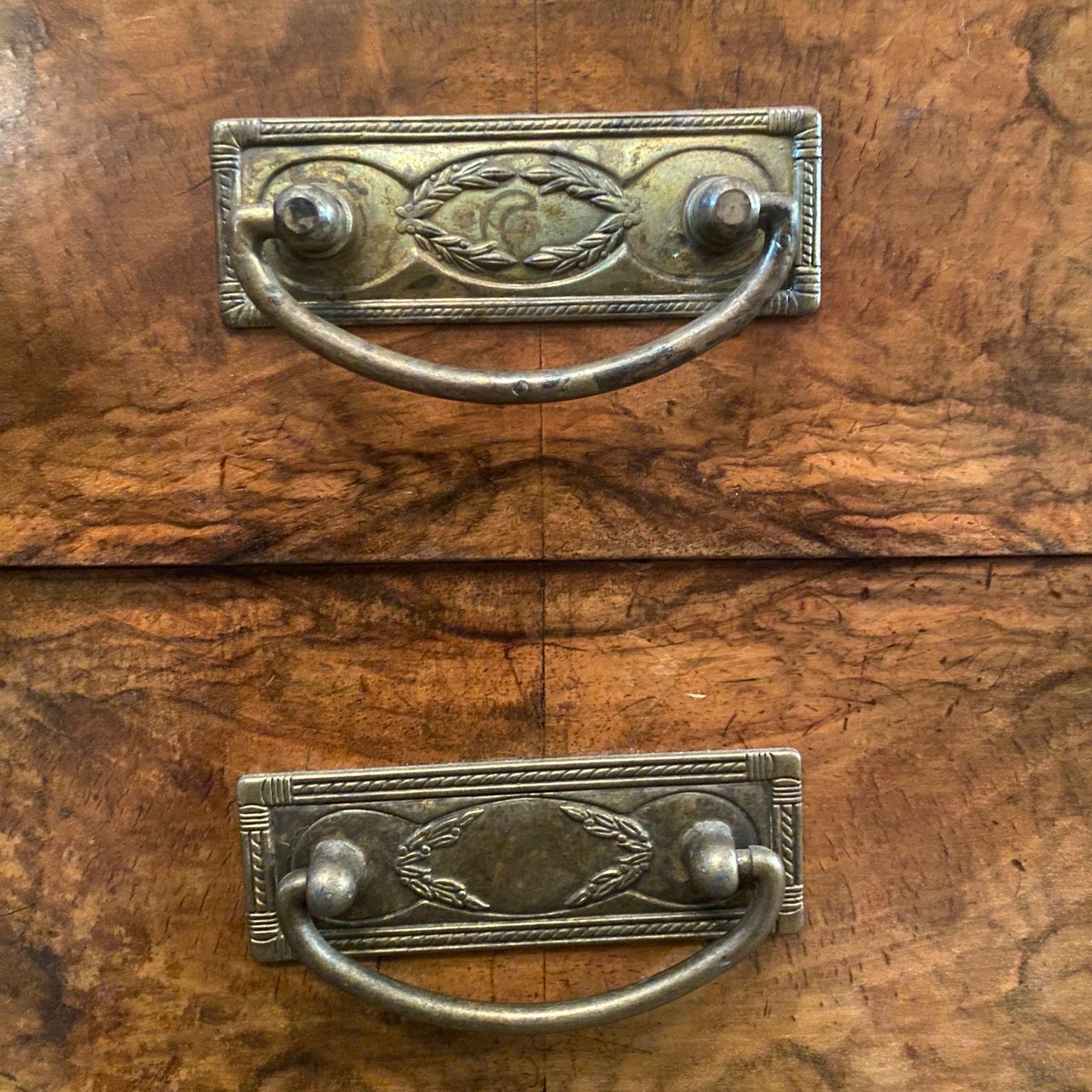 Close-up of an old wooden drawer with metal handles