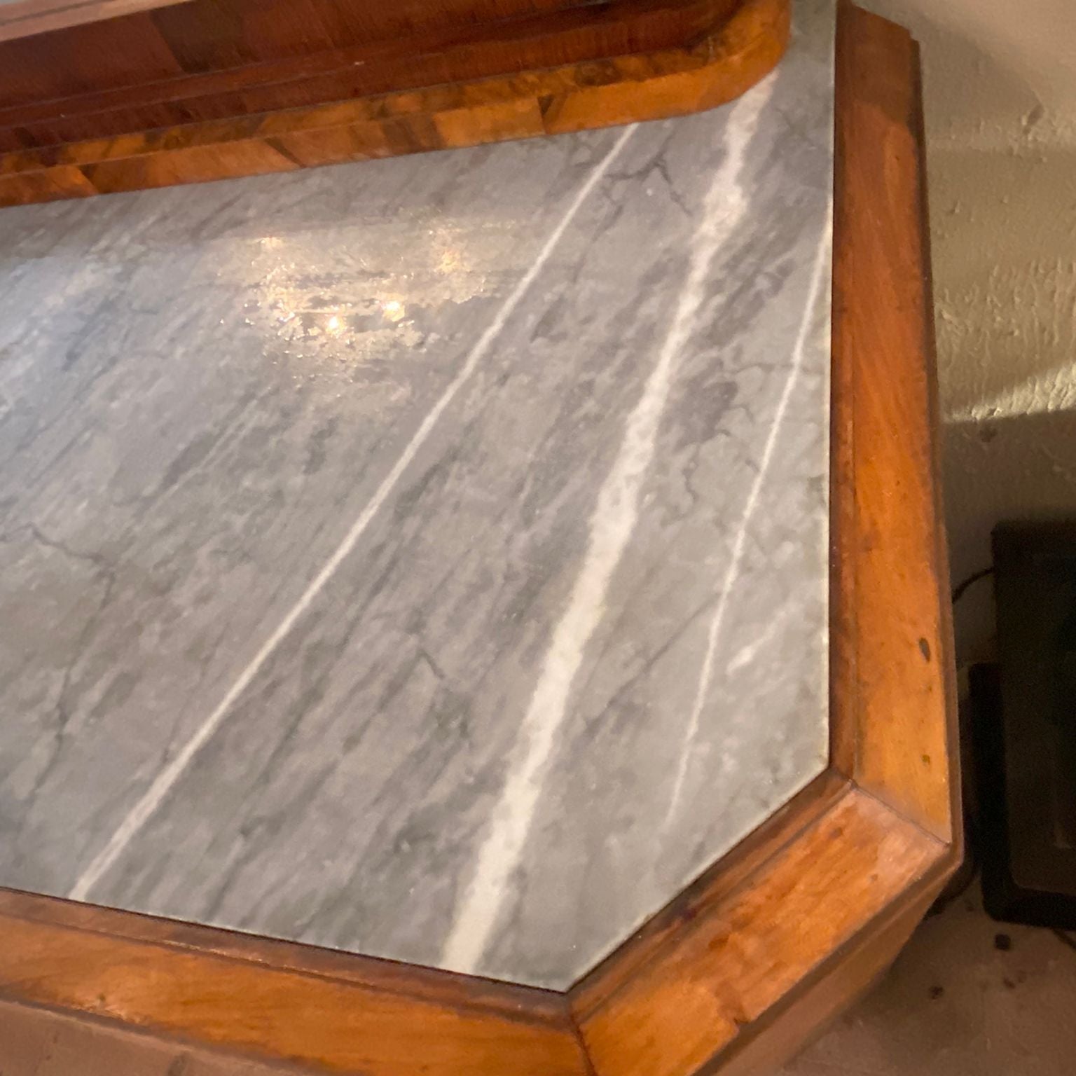 Marble countertop with wooden frame and visible wear
