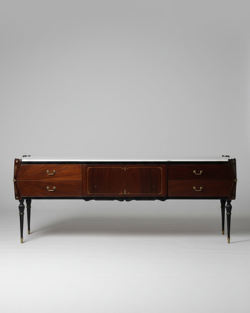 Wooden dresser with a dark finish in a room with sunlight streaming through a window.