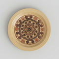 Decorative plate with intricate design on a white surface