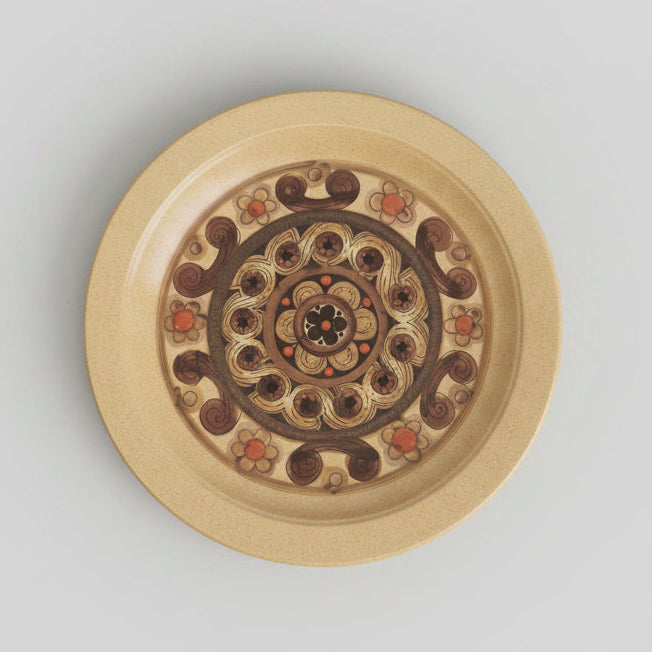 Decorative plate with intricate design on a white surface