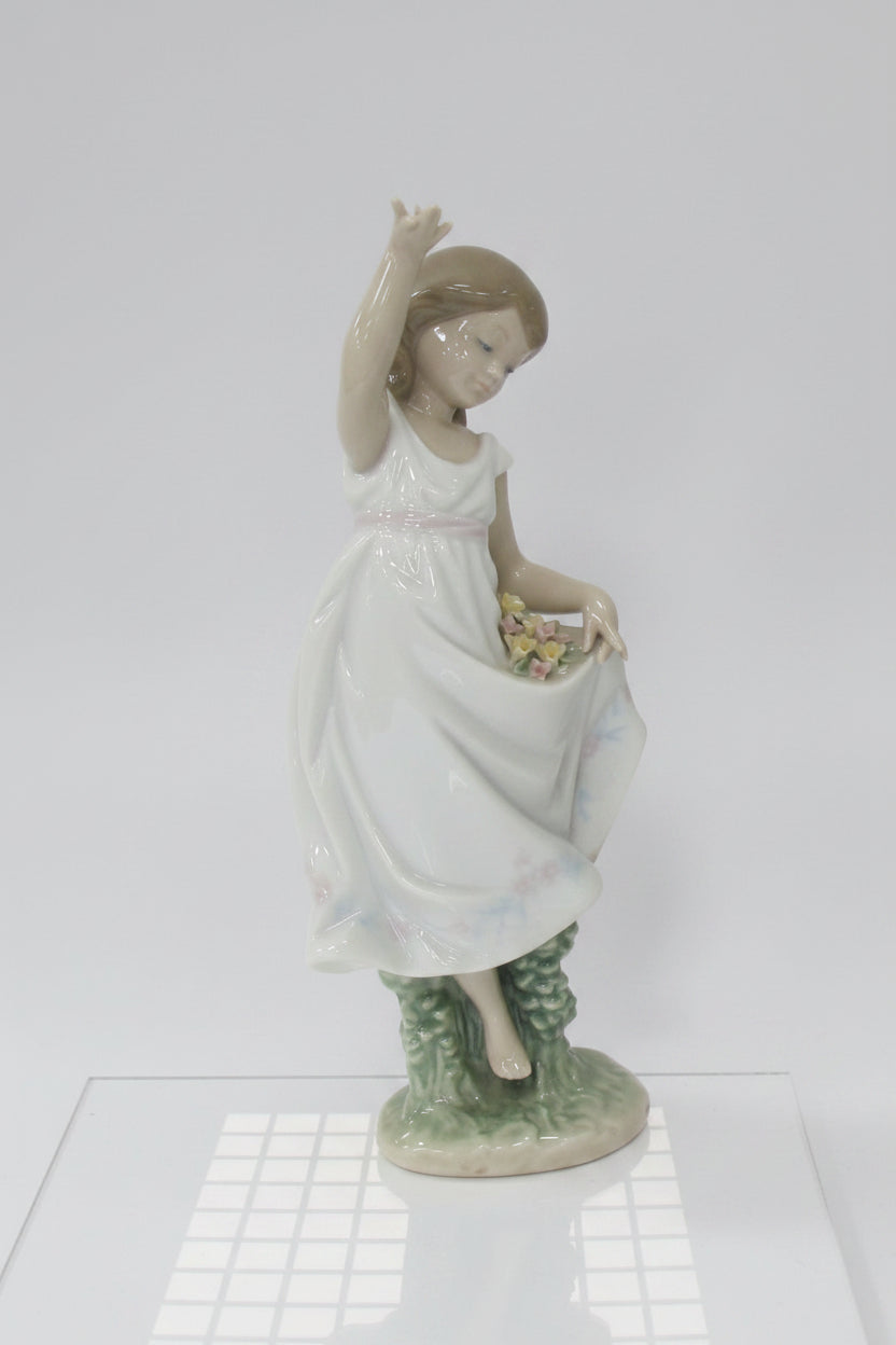 A collection of decorative items on a white studio background, including four small porcelain figurines and a large dark red crystal candle holder with hanging clear crystals.