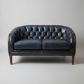 Blue leather sofa against a beige wall