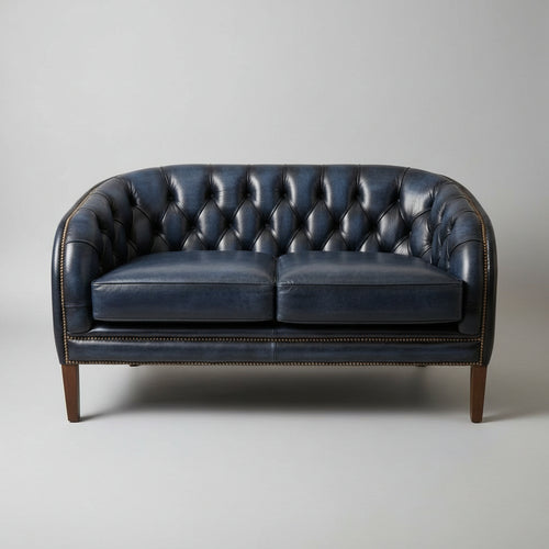 Blue leather sofa against a beige wall