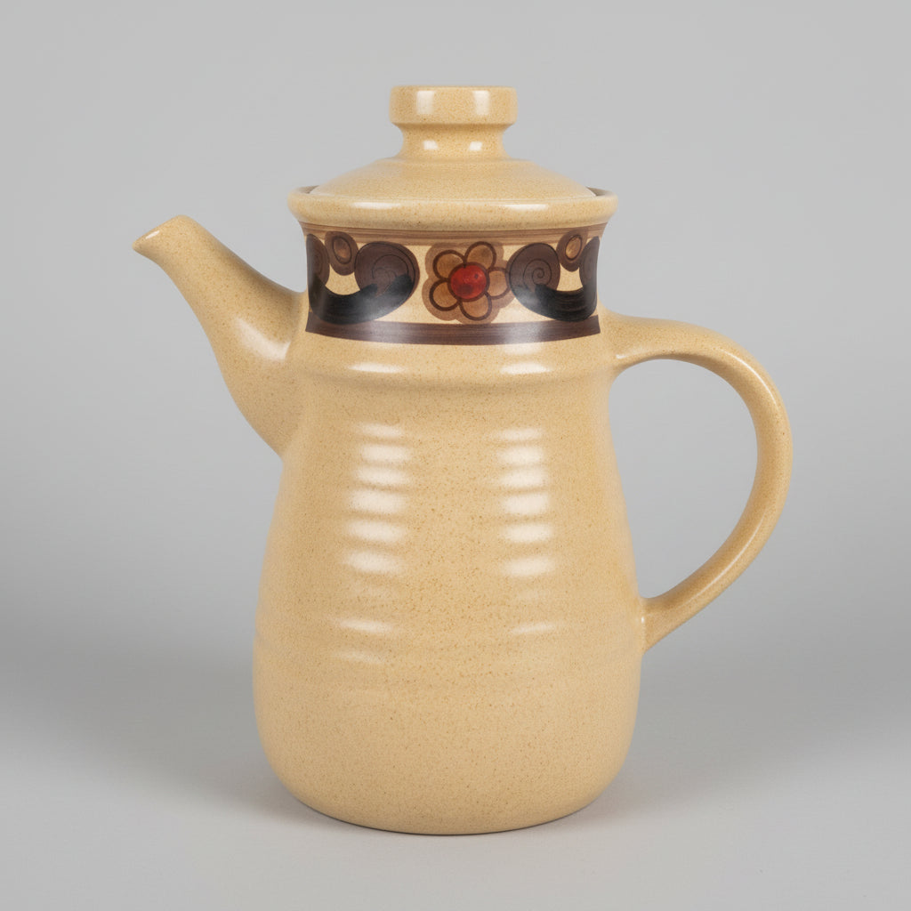 Beige teapot with decorative elements on a white surface