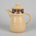 Beige teapot with decorative elements on a white surface