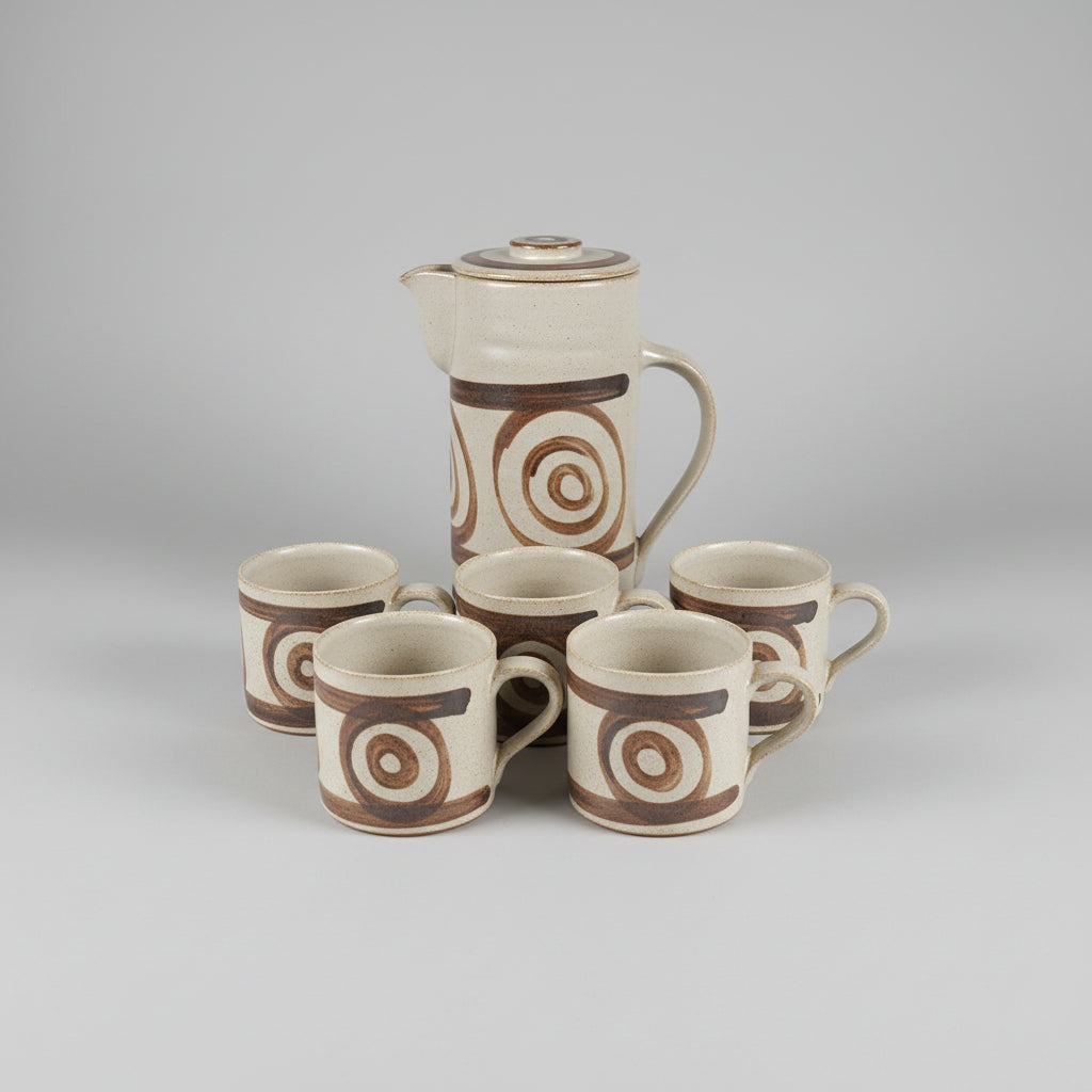 Set of ceramic cups with spiral patterns on a white surface