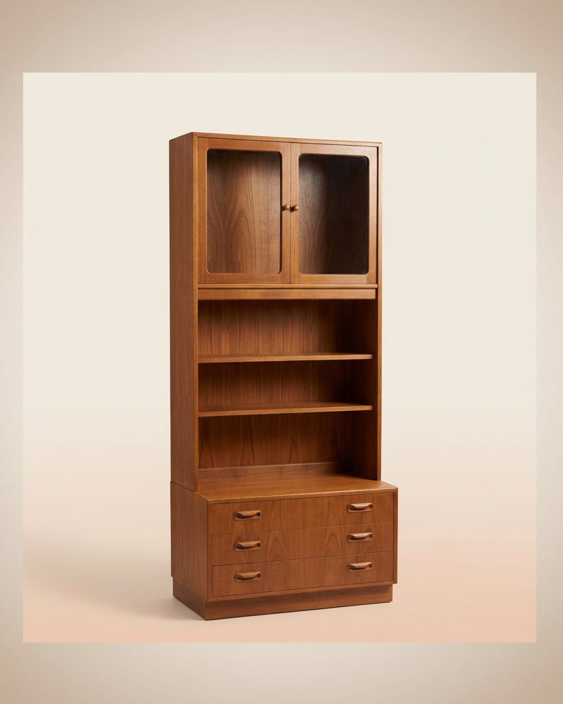Wooden bookshelf with glass doors and drawers on a beige background