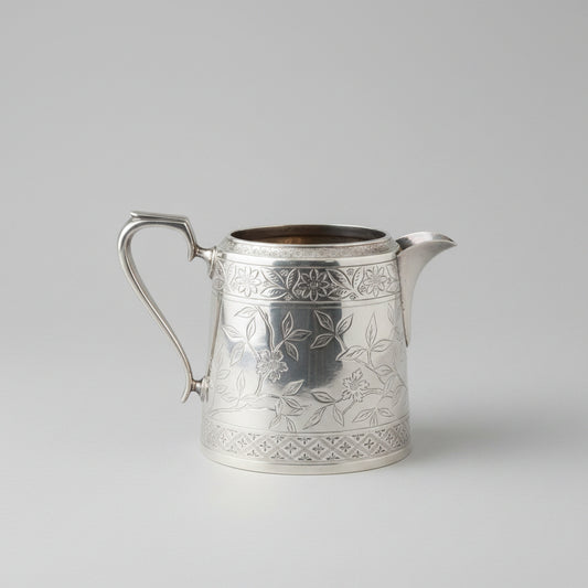 Decorative silver teapot on a wooden table with a blurred background