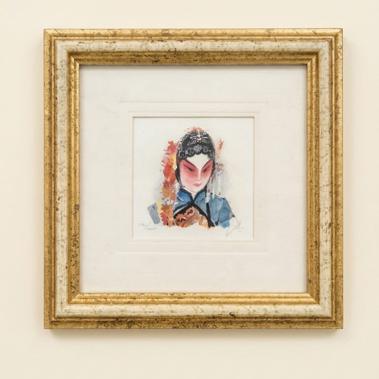 Framed artwork of a traditional Chinese opera mask on a beige wall