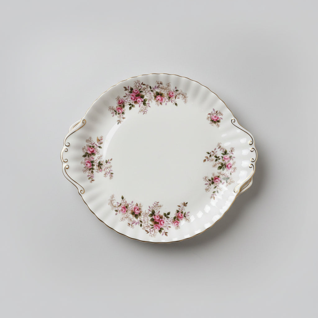 Decorative ceramic plate with floral patterns on a wooden surface