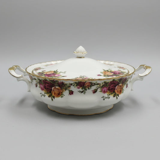 Decorative floral-patterned ceramic tureen on a table with a blurred background