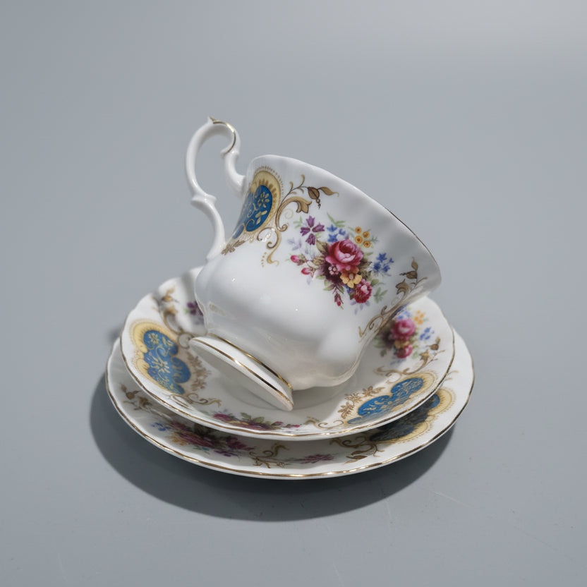 Decorative teacup and saucer set with floral patterns on a gray background