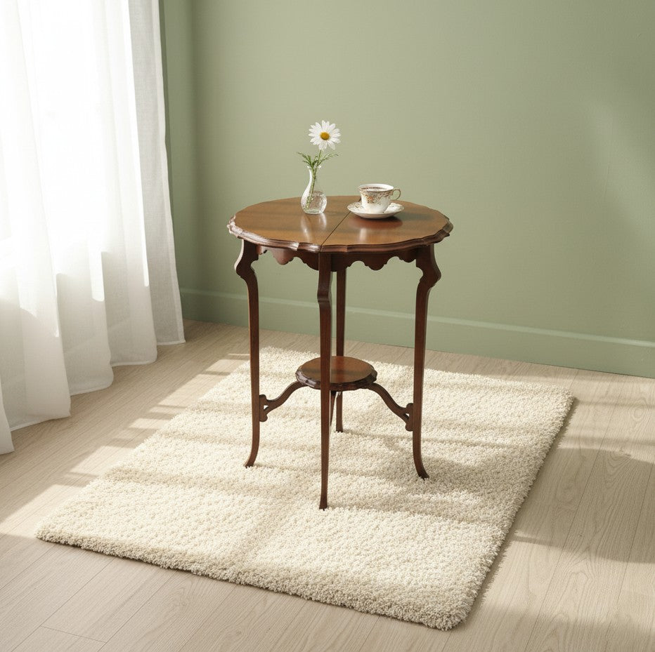 AN EDWARDIAN TWO TIER CENTRE TABLE WITH PIE-CRUST EDGE