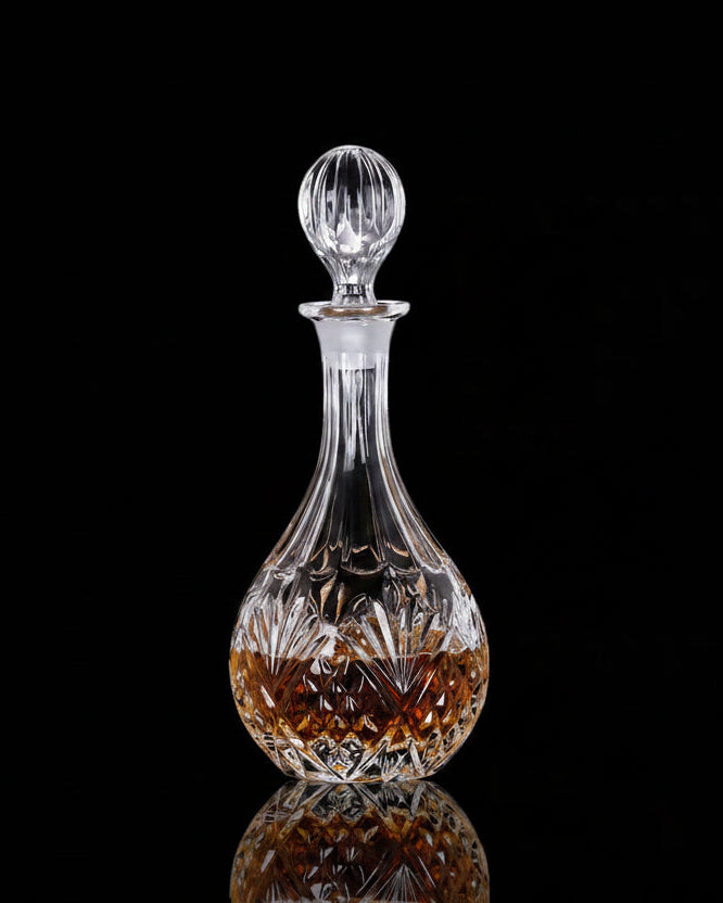 A clear glass decanter with a faceted stopper and a cut crystal pattern, shown on a black background with product details and price text overlaid.