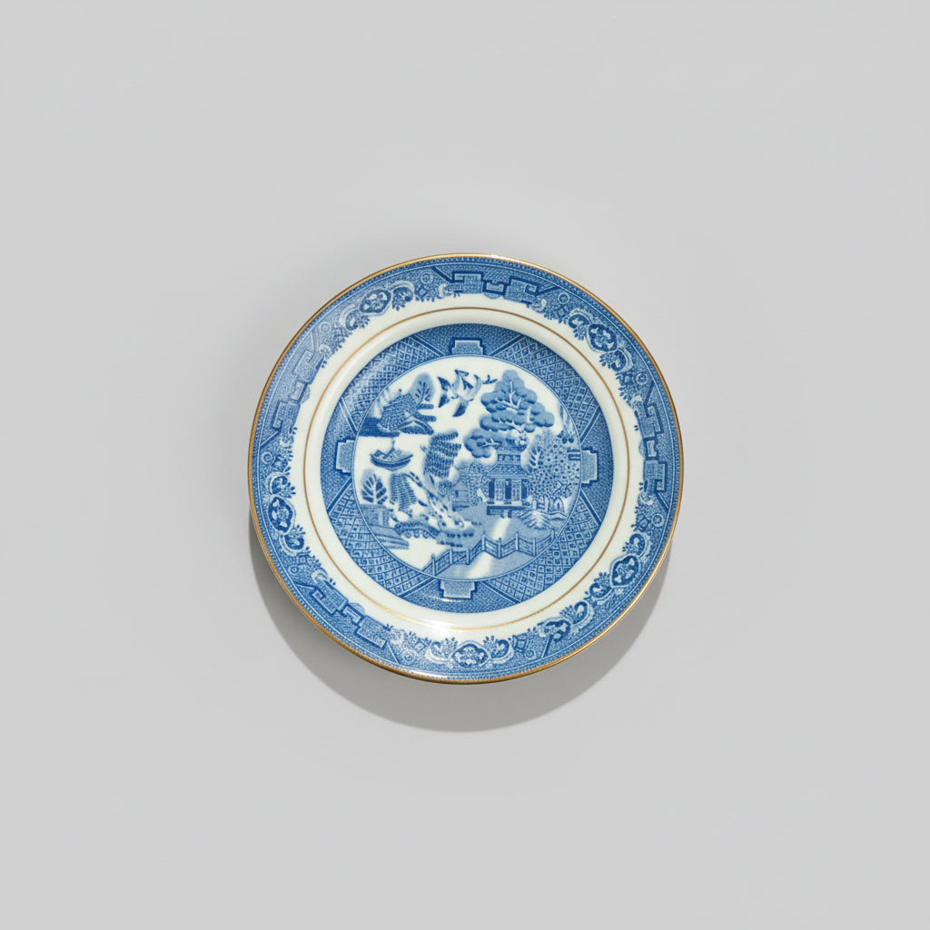 Blue and white ceramic plate with intricate design on a gray background