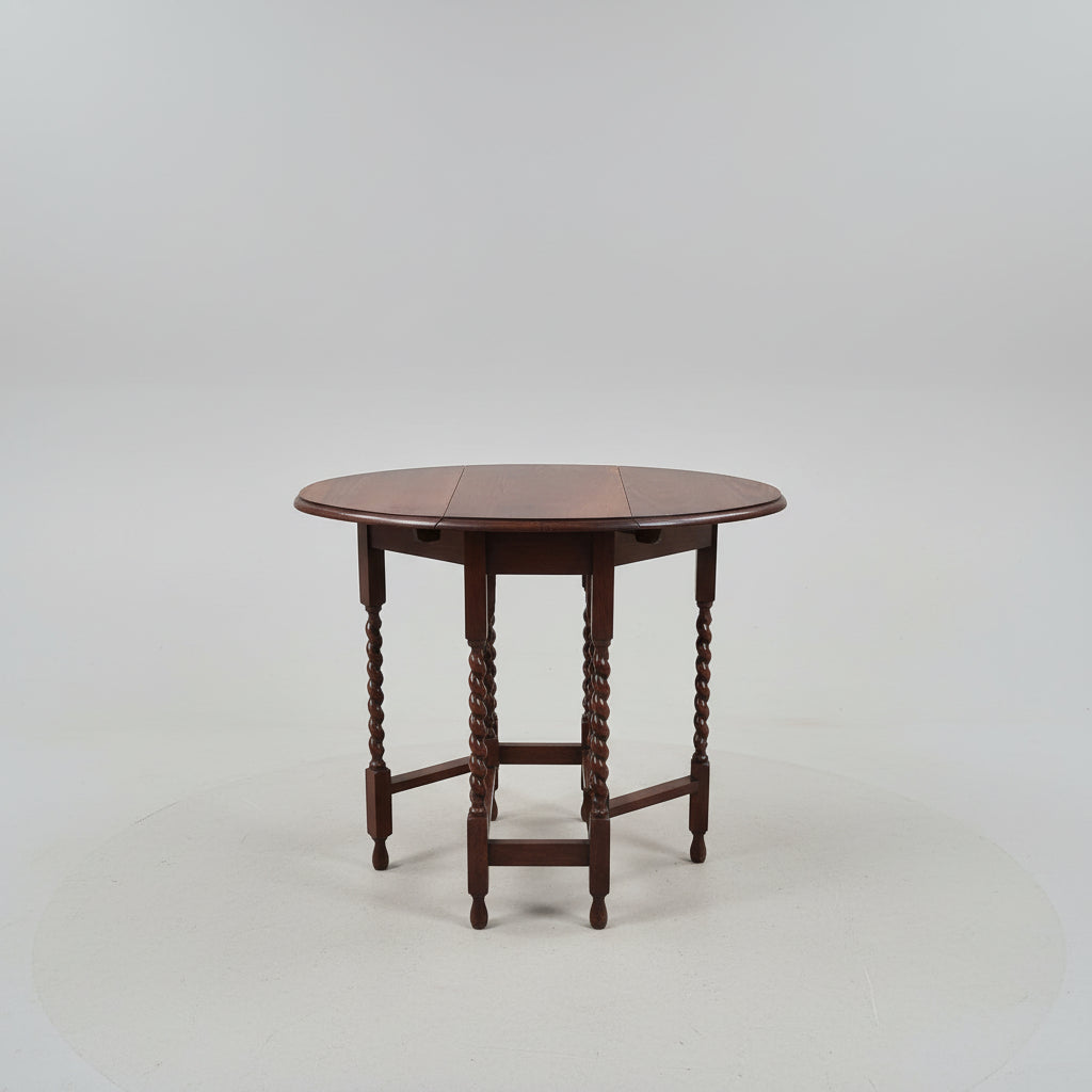 Wooden drop-leaf table on a plain background