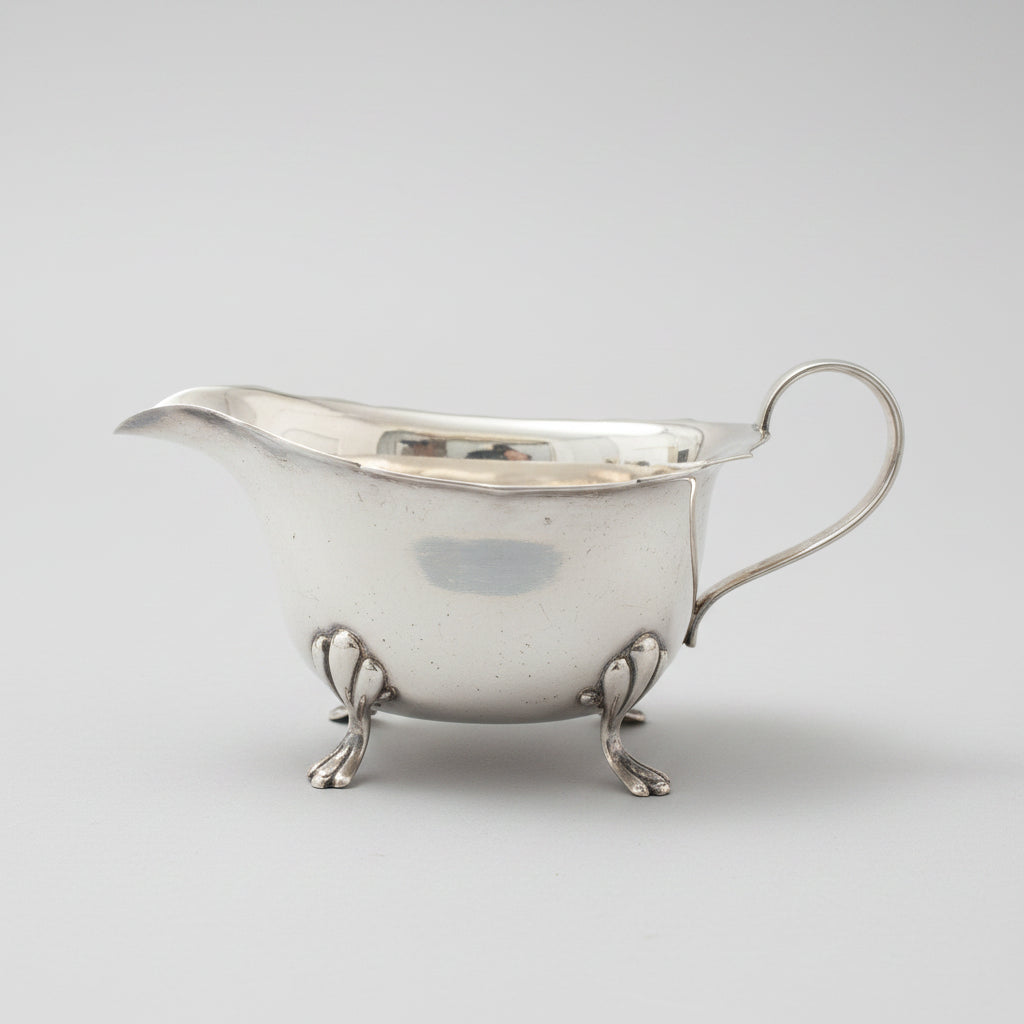 Silver gravy boat on legs