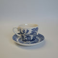Blue and white teacup with intricate design on a white background