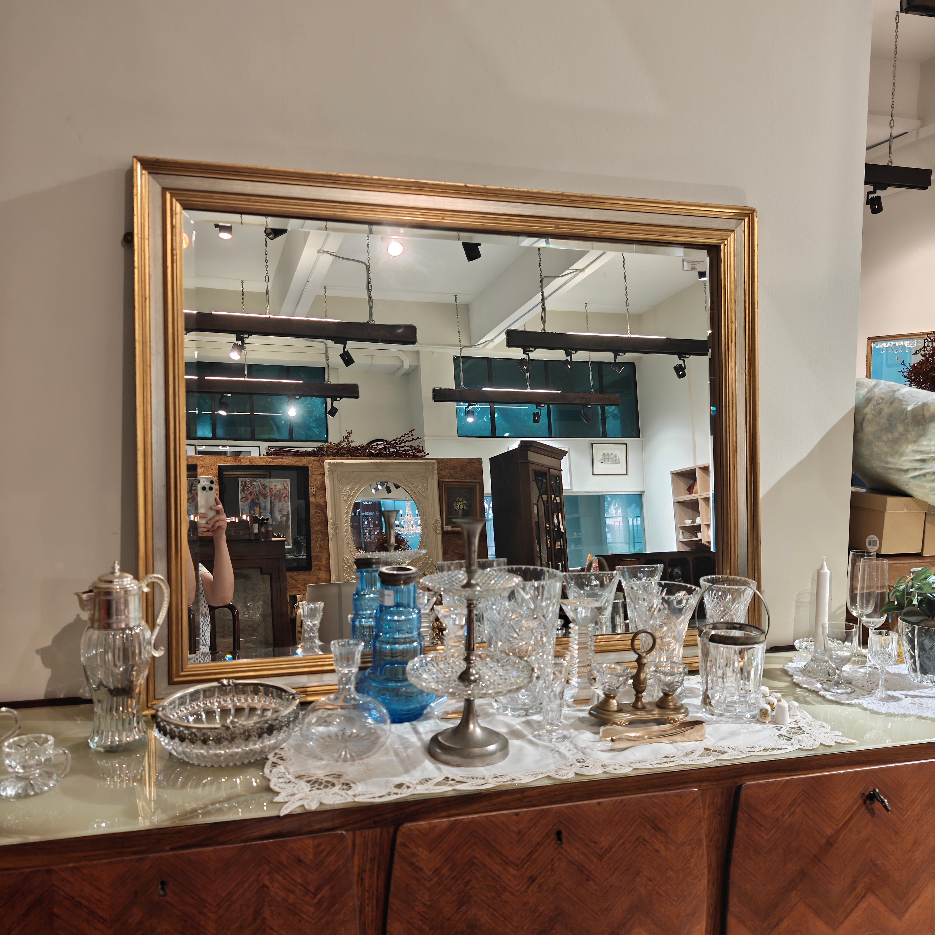 Large mirror on a wooden dresser with decorative items