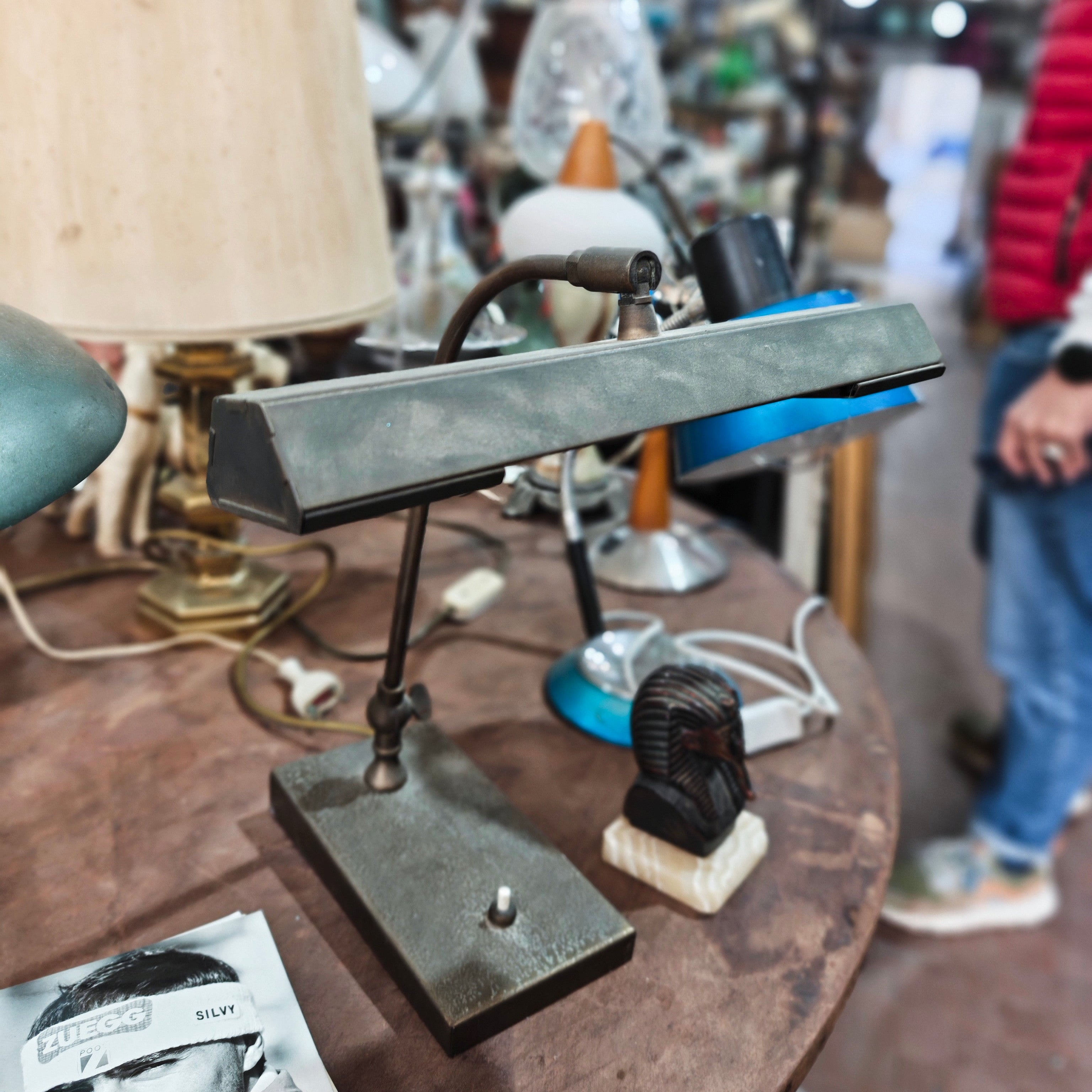 Vintage-style lamp on a table with blurred people in the background