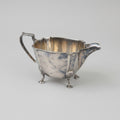 Antique silver plated milk jar with a handle and spout