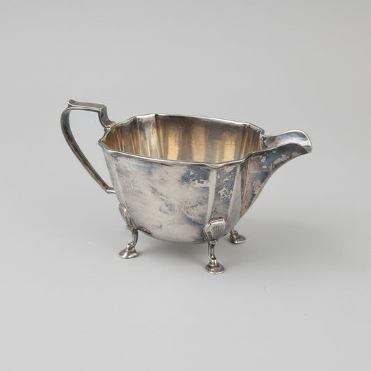 Antique silver plated milk jar with a handle and spout