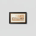 A framed watercolor landscape print depicting a coastal town scene, mounted on a wooden wall. The artwork features warm sepia and brown tones with a black double-frame and white matting.