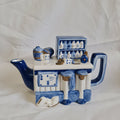 Decorative ceramic piece with blue and white design on a white fabric background