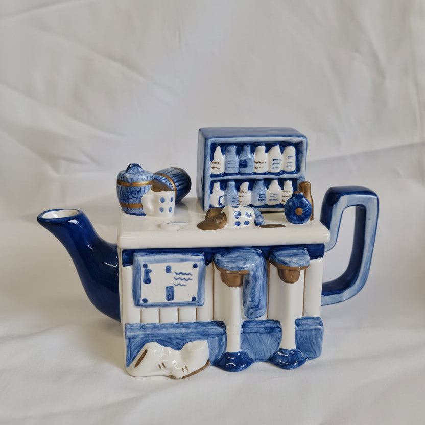 Decorative ceramic piece with blue and white design on a white fabric background