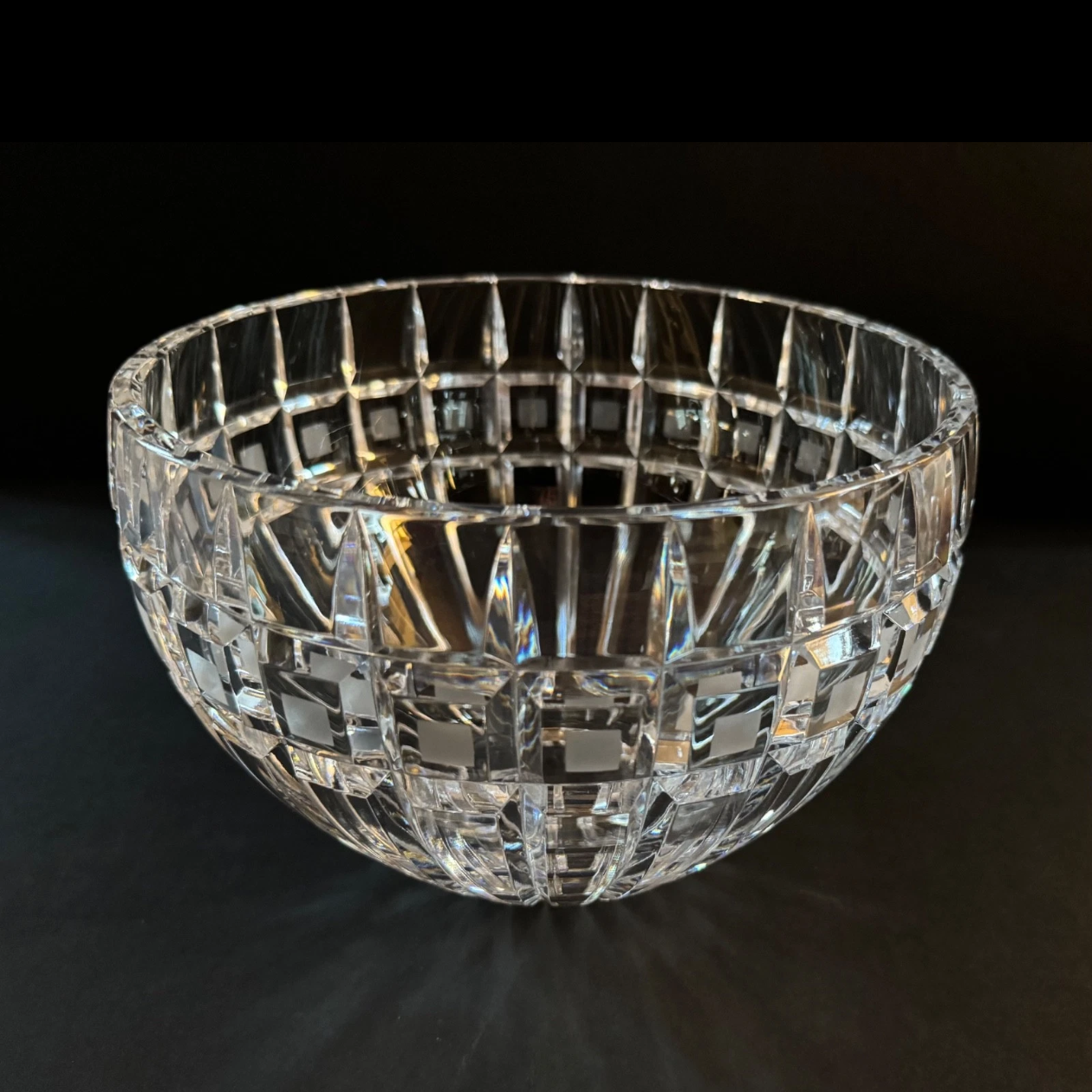 Crystal bowl with grid pattern on a dark background