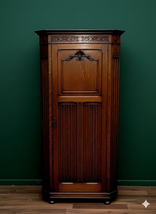 AN EARLY 20TH CENTURY OAK HALL WARDROBE WITH LINEN FOLD AND FOLIATE DECORATION 38" WIDE