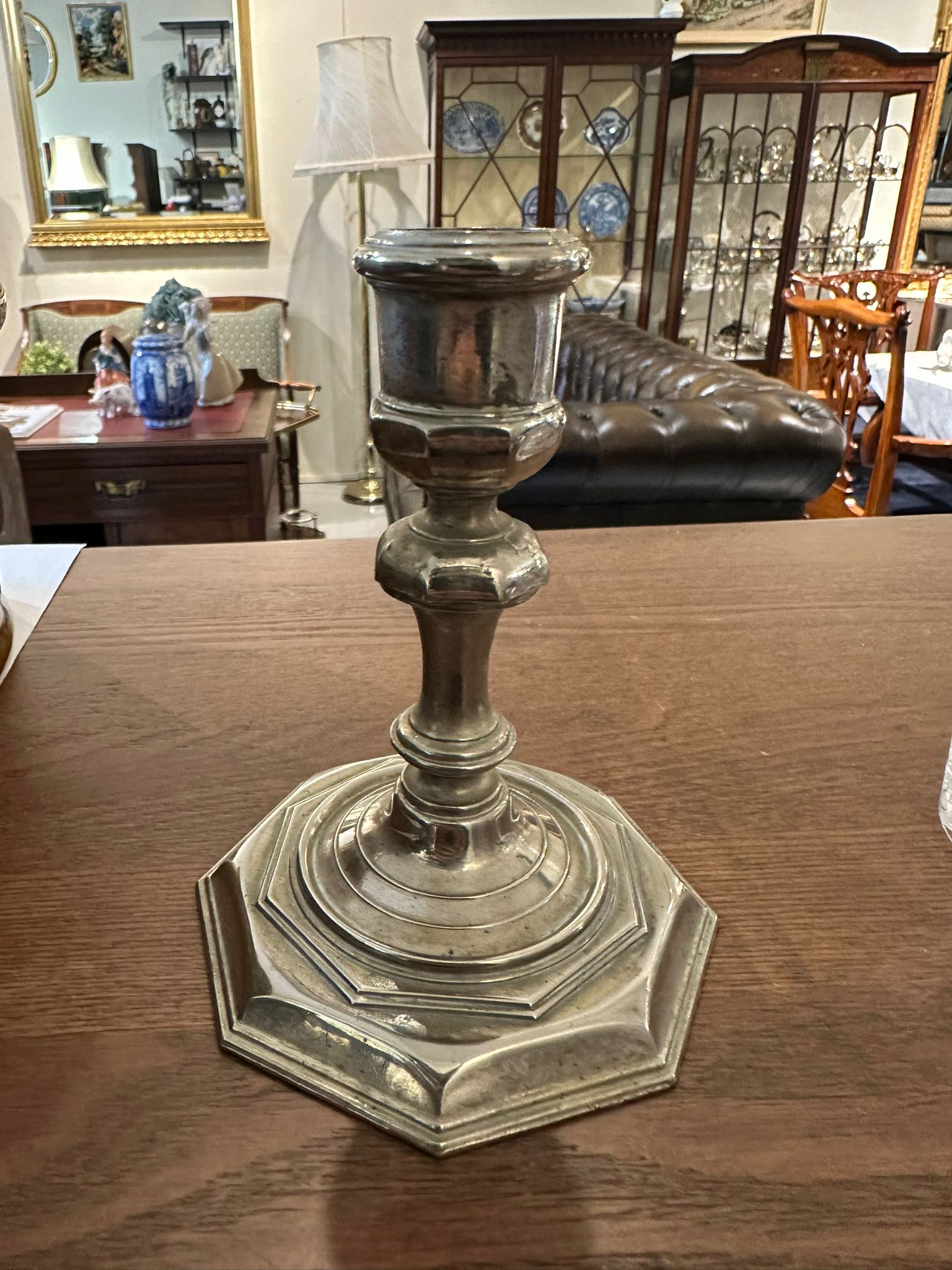 A silver-plated candlestick with stable hexagonal base