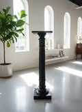 A late 19th Century ebonised torchere with fluted turned pedestal column, height 105cm,