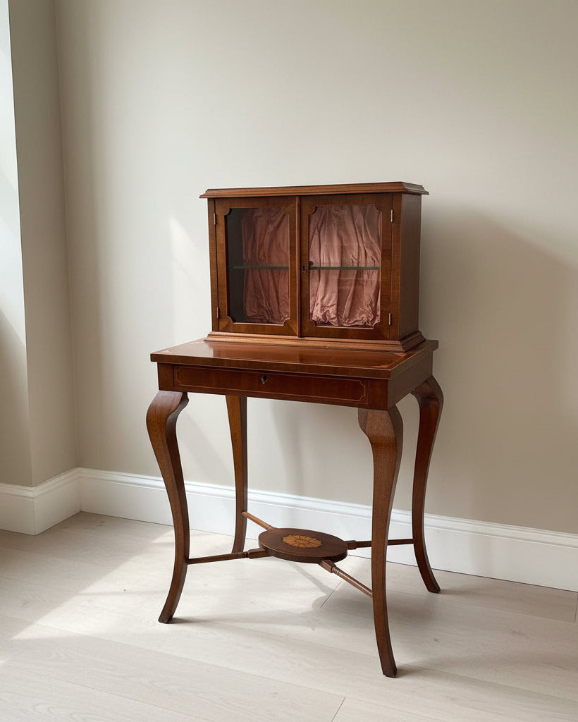 Wooden desk with glass cabinet doors in a room setting
