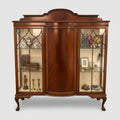 Wooden display cabinet with glass doors on a white background