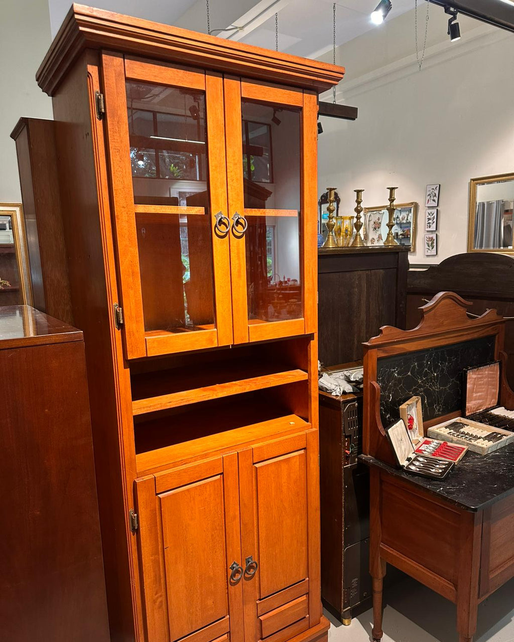 Wooden cabinet with glass doors in an indoor setting