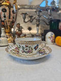 Dresden tea cup and saucer set features a delicate floral design with intricate gold accents